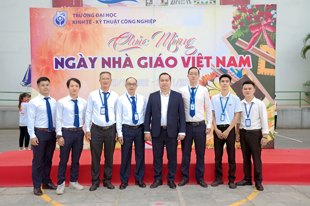 A group of men standing in front of a banner

Description automatically generated