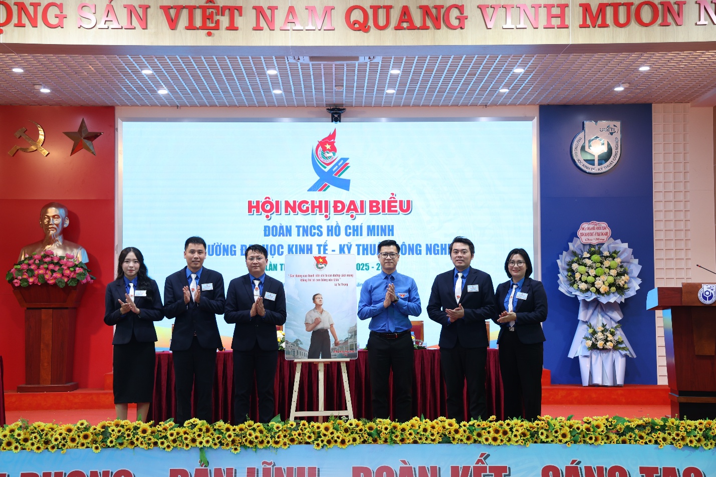 A group of people standing on a stage Description automatically generated