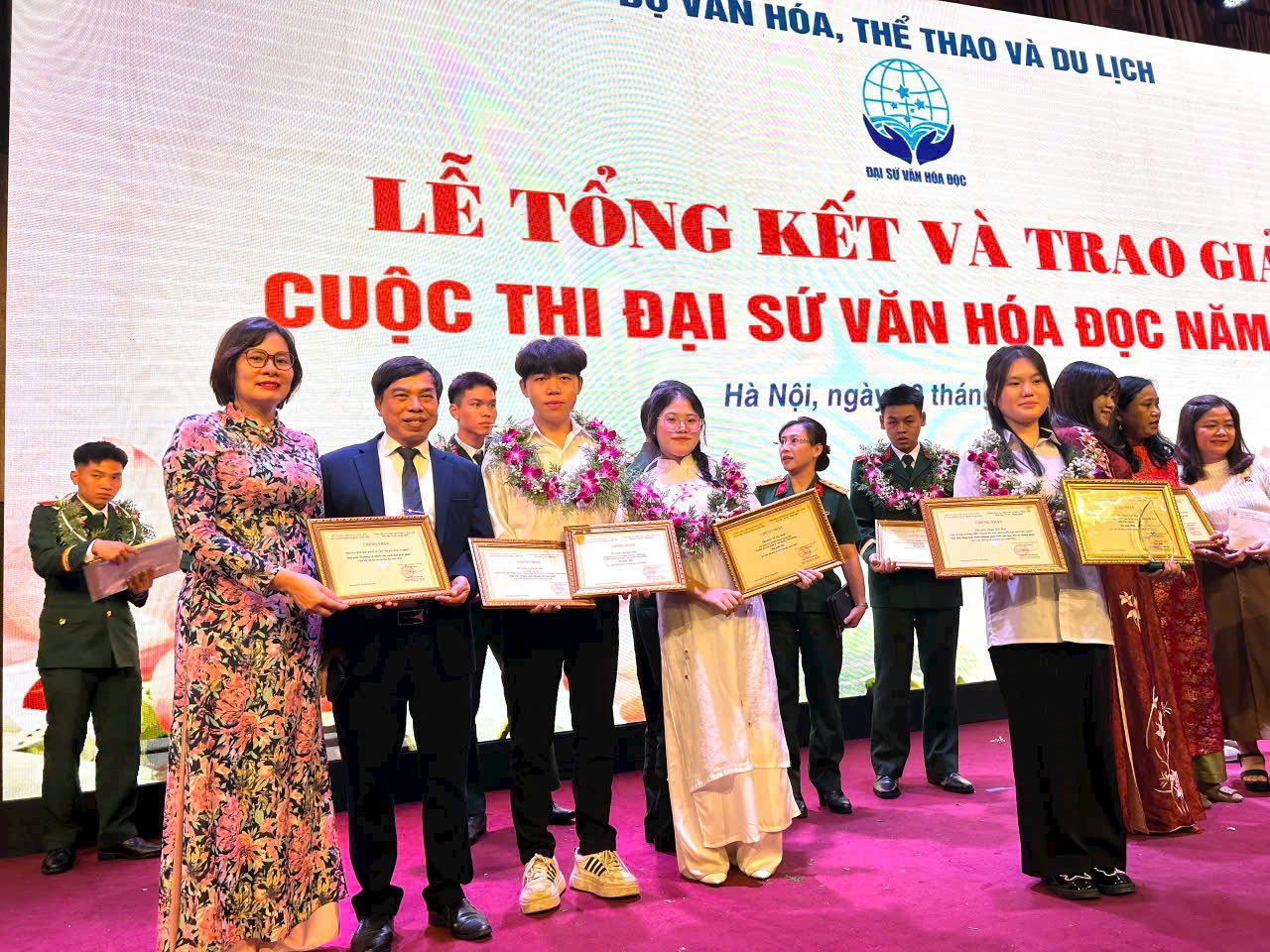 A group of people holding certificates Description automatically generated