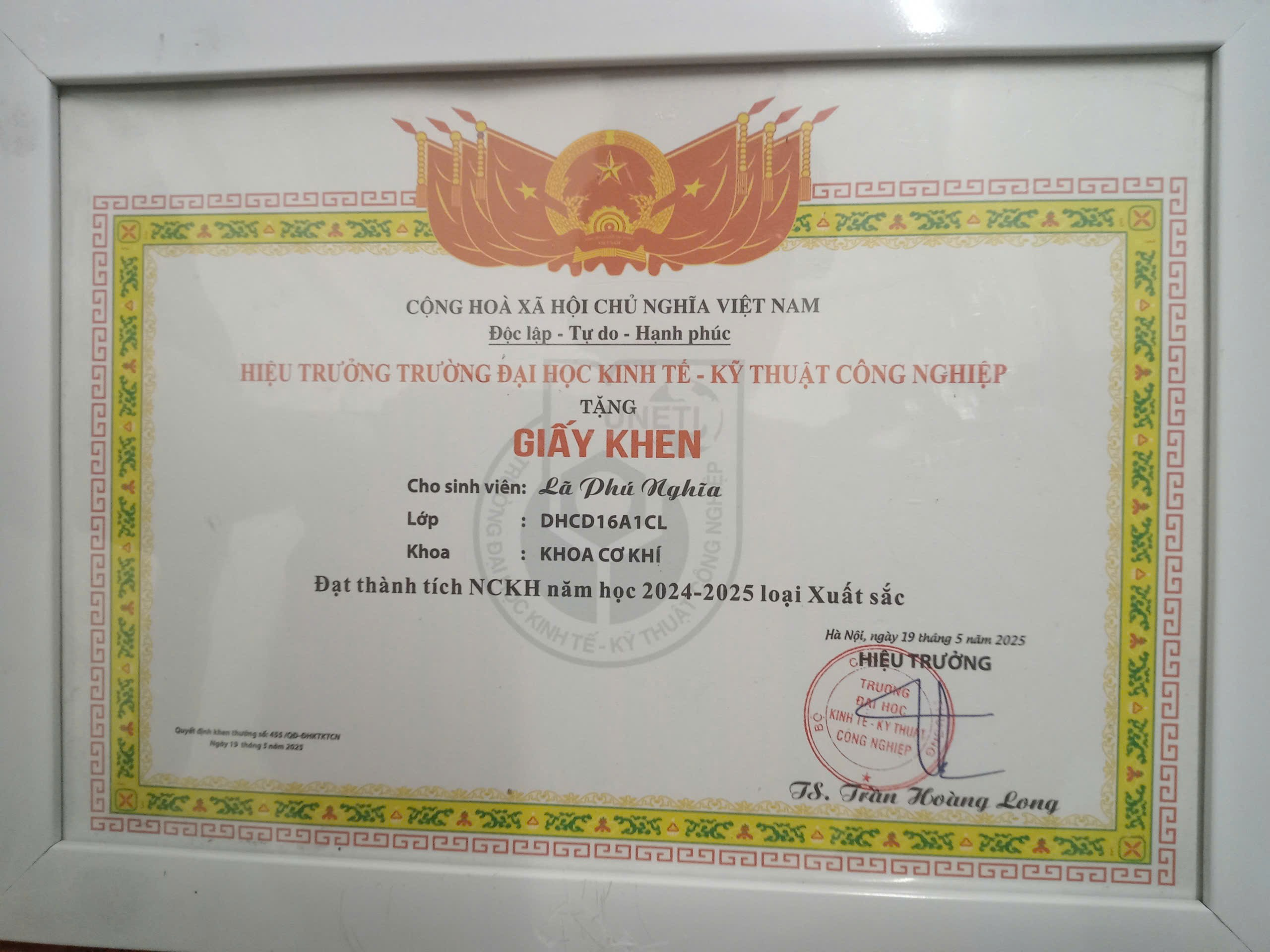 A certificate on a white surface Description automatically generated
