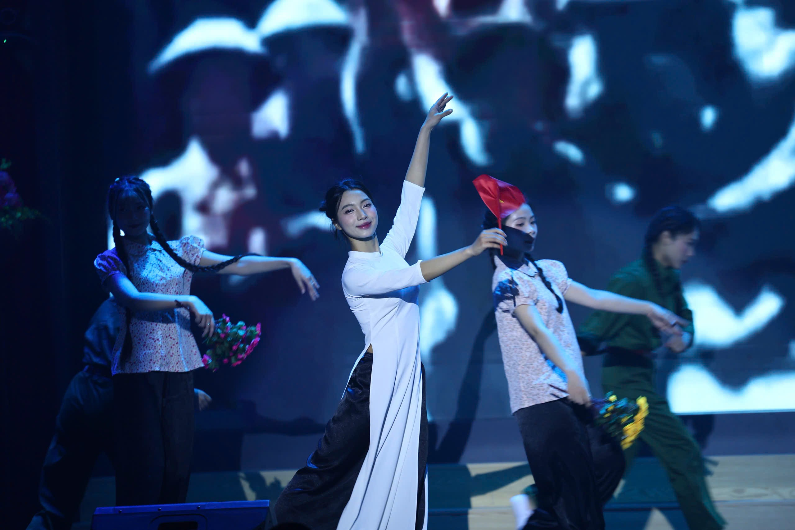 A group of people dancing on a stage AI-generated content may be incorrect.