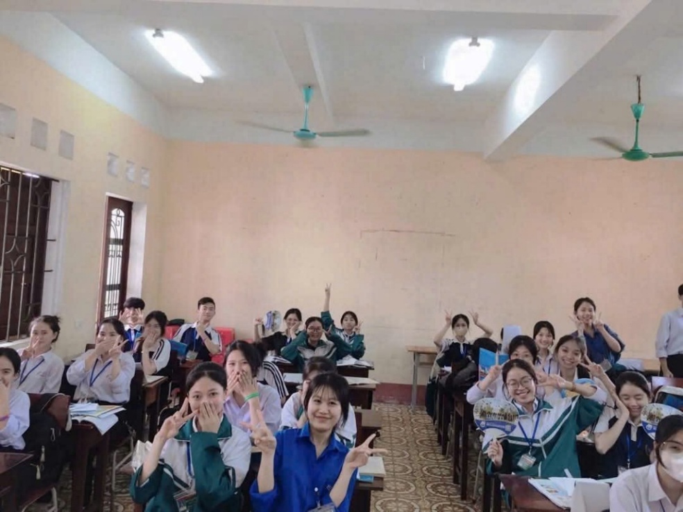 A group of people in a classroom Description automatically generated