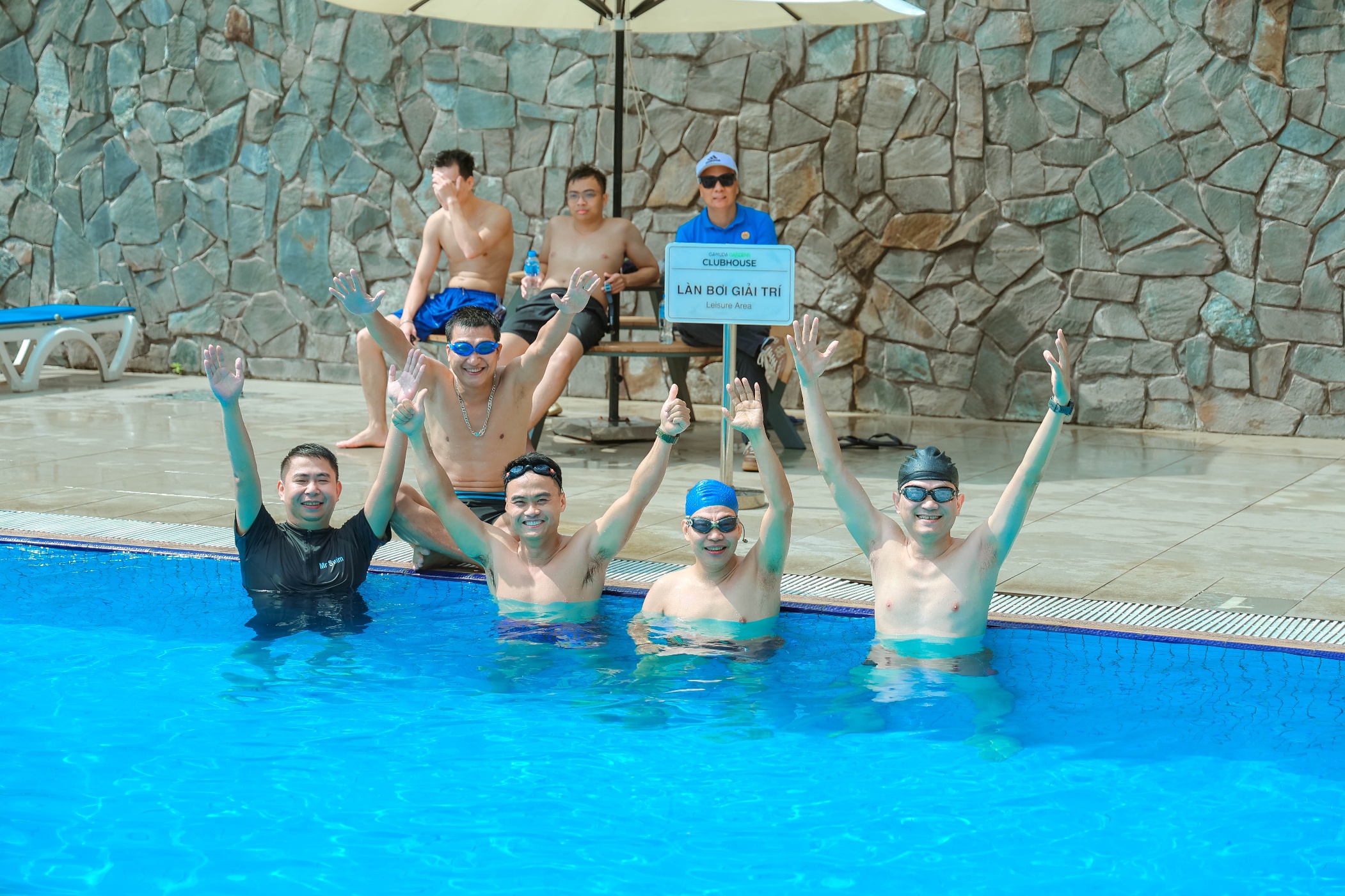 A group of people in a pool Description automatically generated