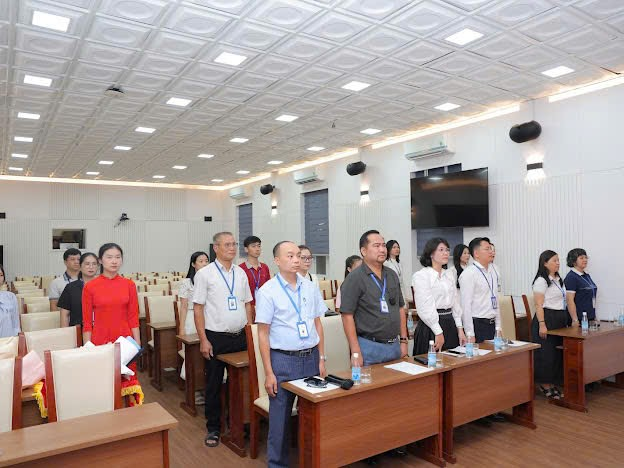 A group of people standing in a room

Description automatically generated