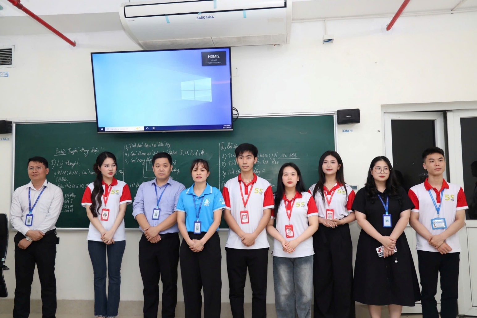 A group of people standing in front of a chalkboard AI-generated content may be incorrect.