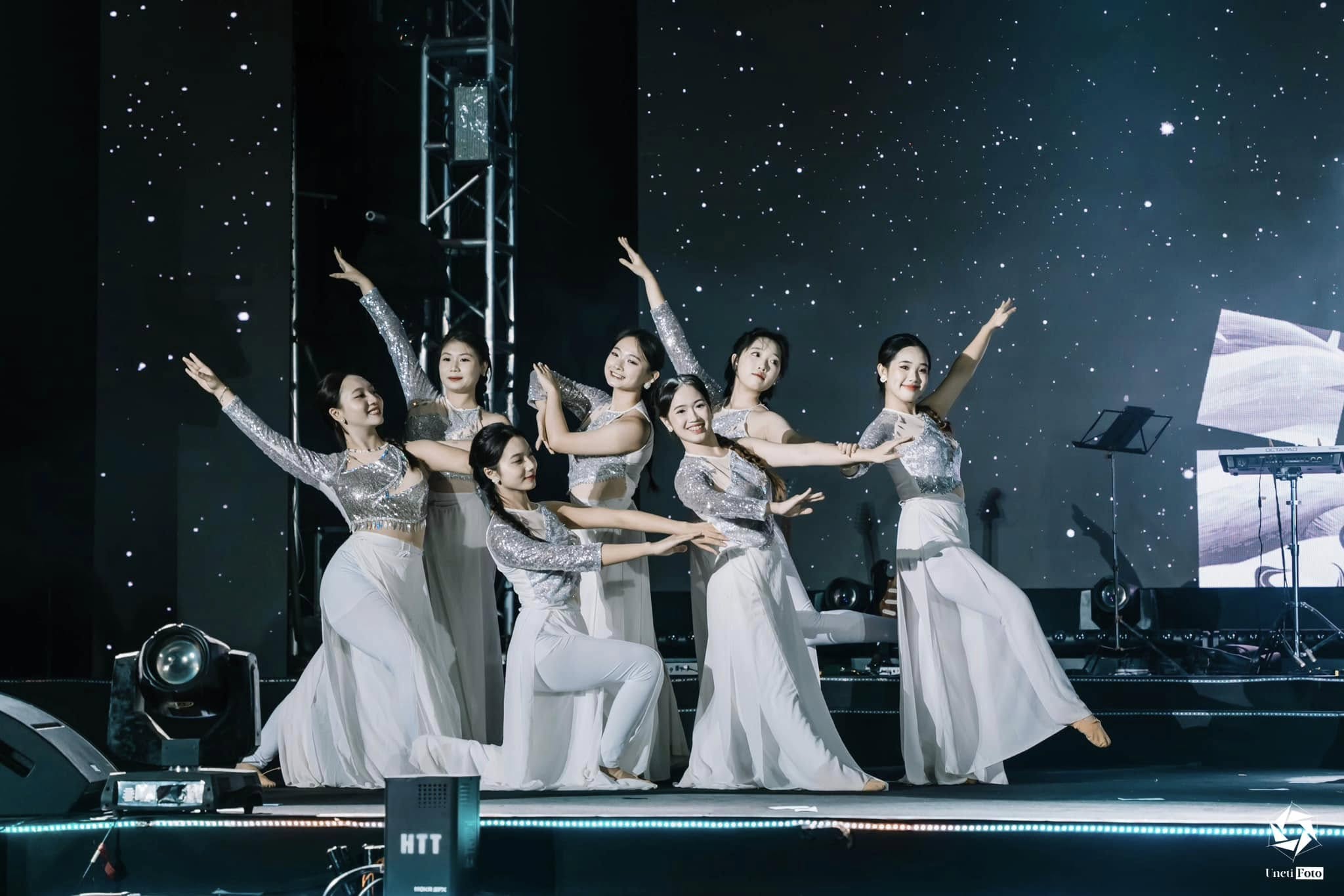 A group of women dancing on a stage AI-generated content may be incorrect.