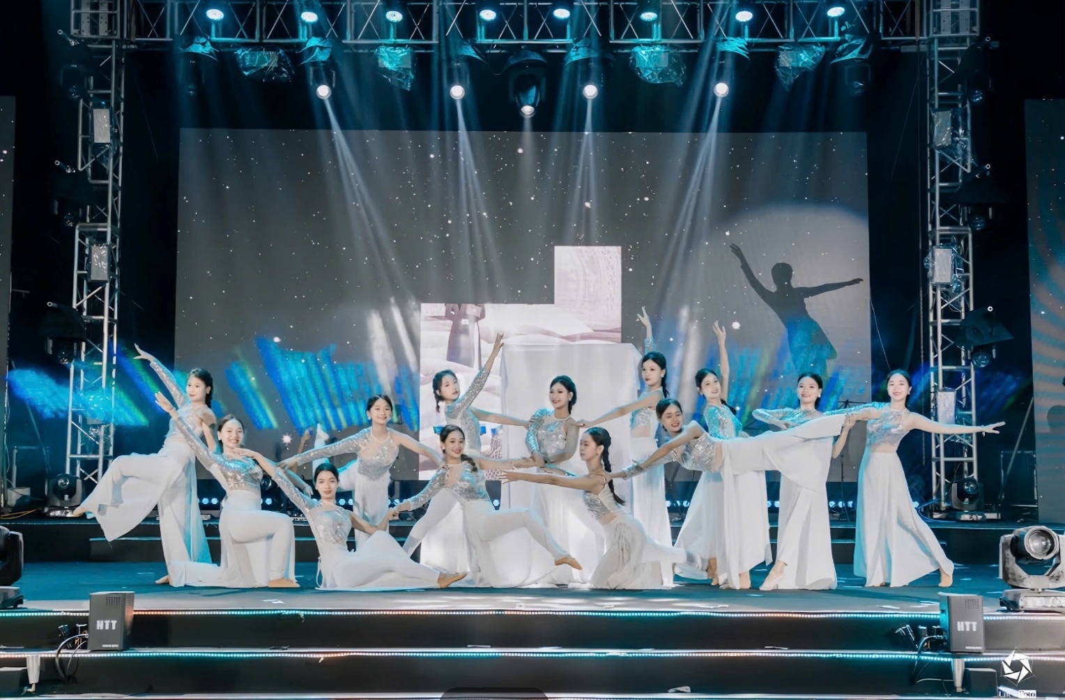 A group of women dancing on stage AI-generated content may be incorrect.