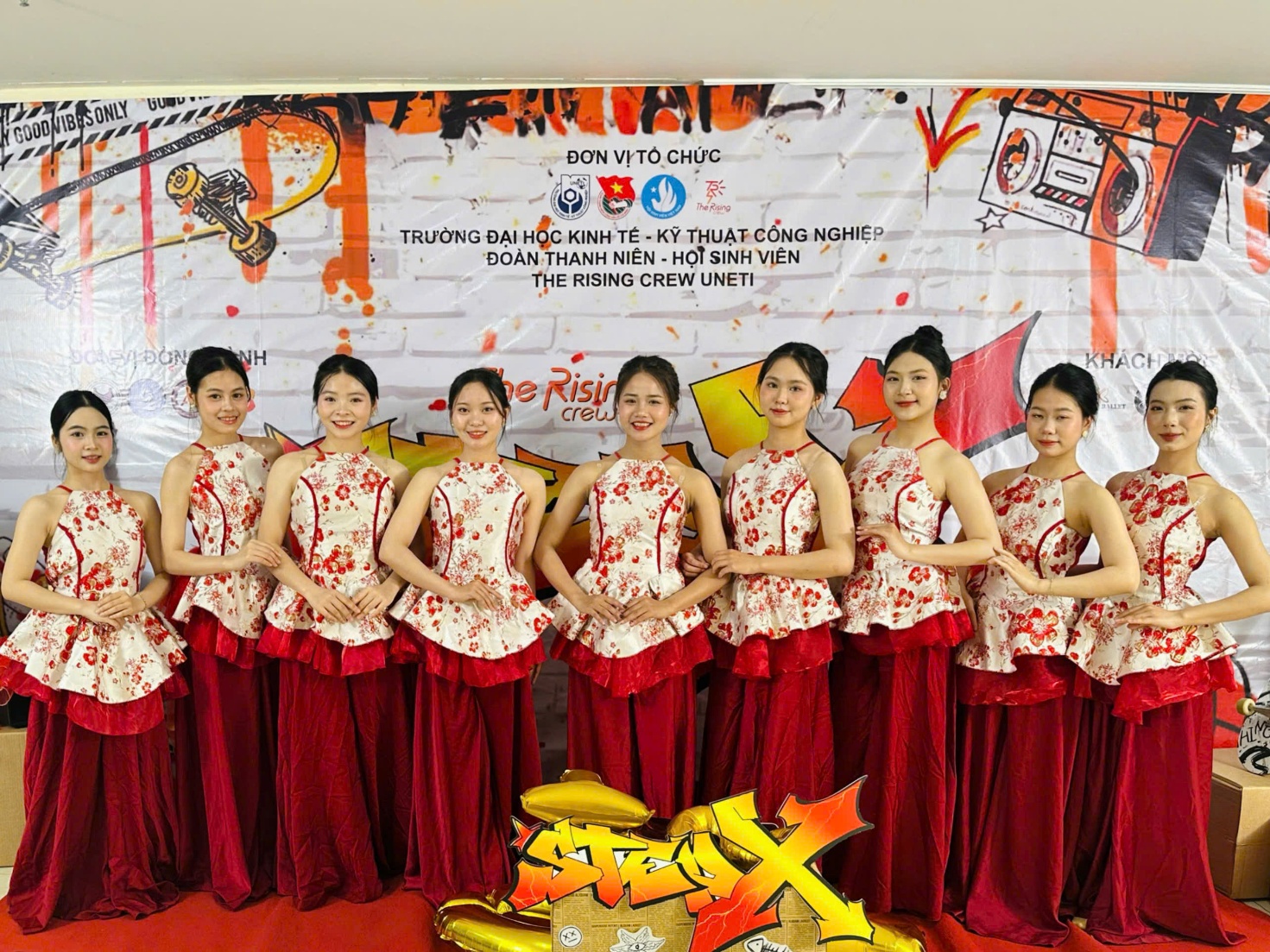 A group of women in red dresses AI-generated content may be incorrect.