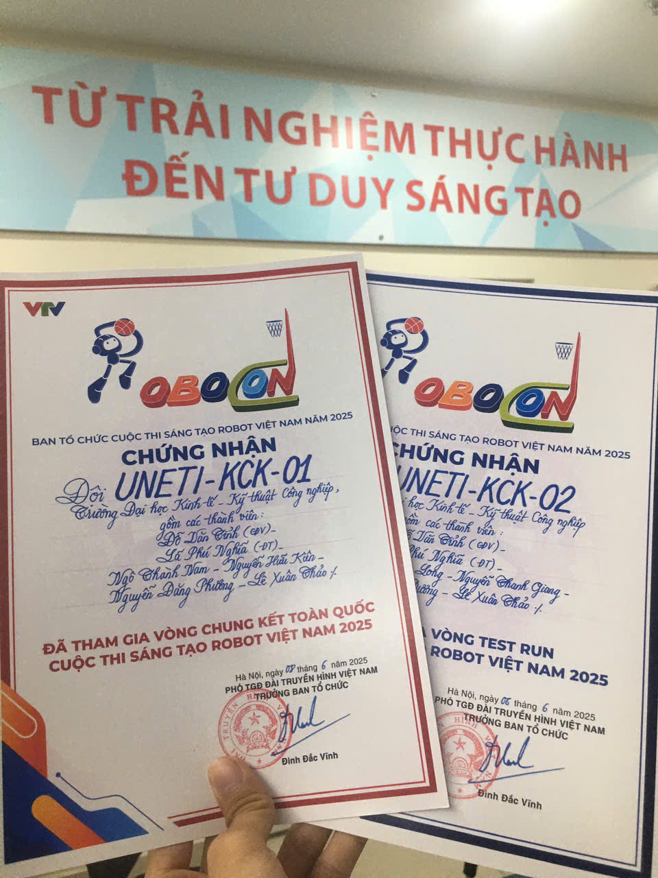 A hand holding a certificate Description automatically generated