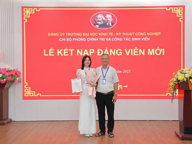 A person and person standing in front of a large sign

Description automatically generated