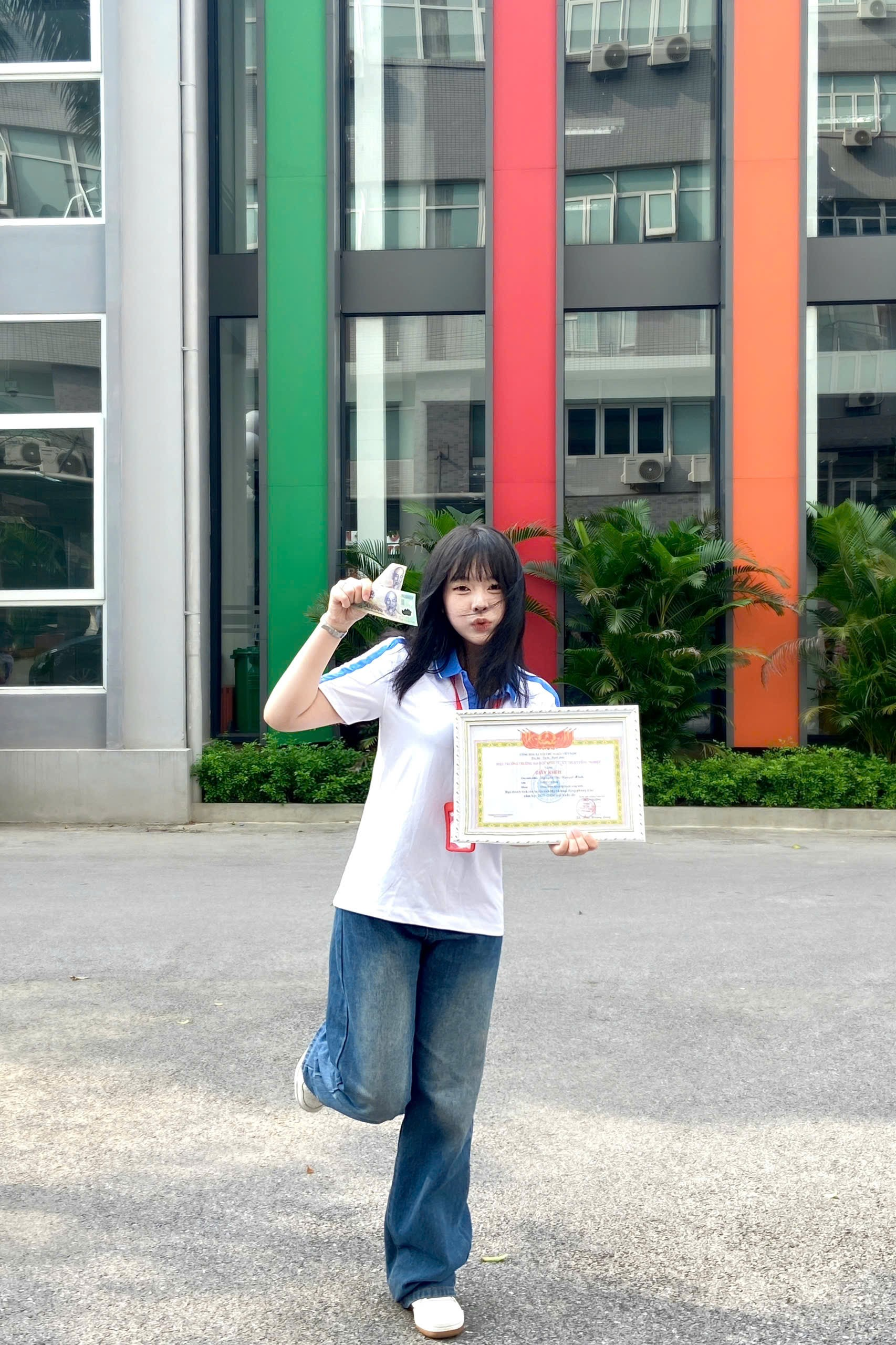 A person holding a certificate and a paper AI-generated content may be incorrect.
