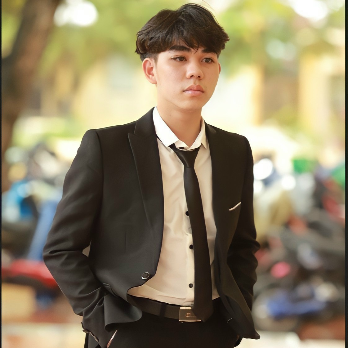 A person in a suit and tie Description automatically generated