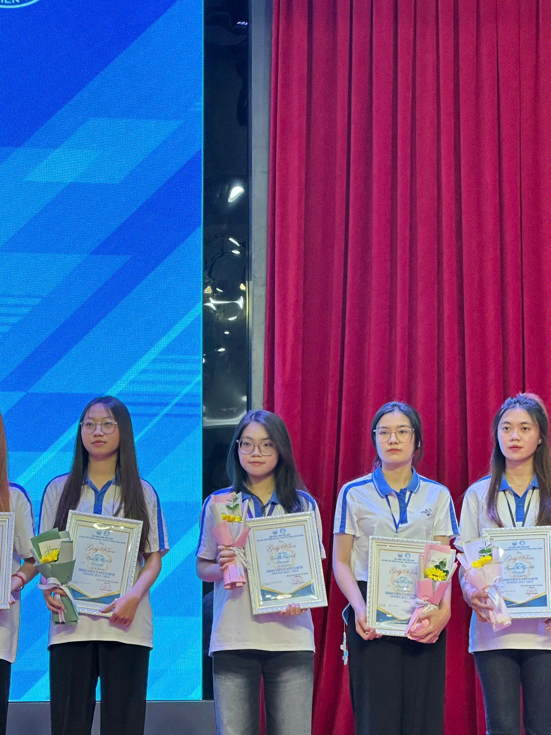 A group of girls holding certificates AI-generated content may be incorrect.