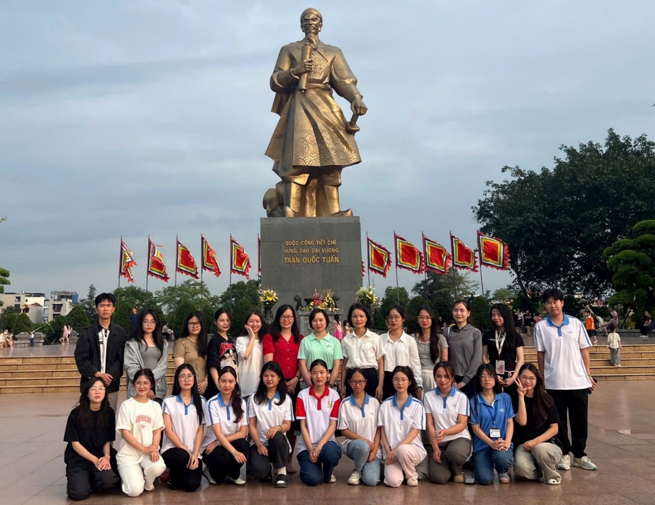 A group of people posing for a photo in front of a statue AI-generated content may be incorrect.