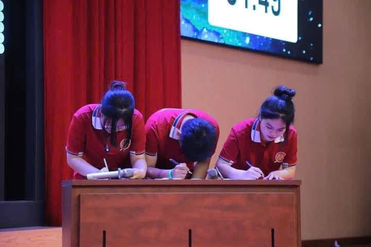 A group of people writing on a desk AI-generated content may be incorrect.
