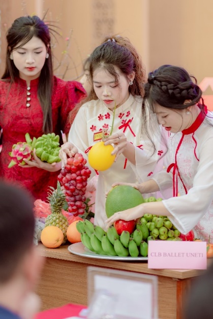 A group of women standing around a table with fruits AI-generated content may be incorrect.