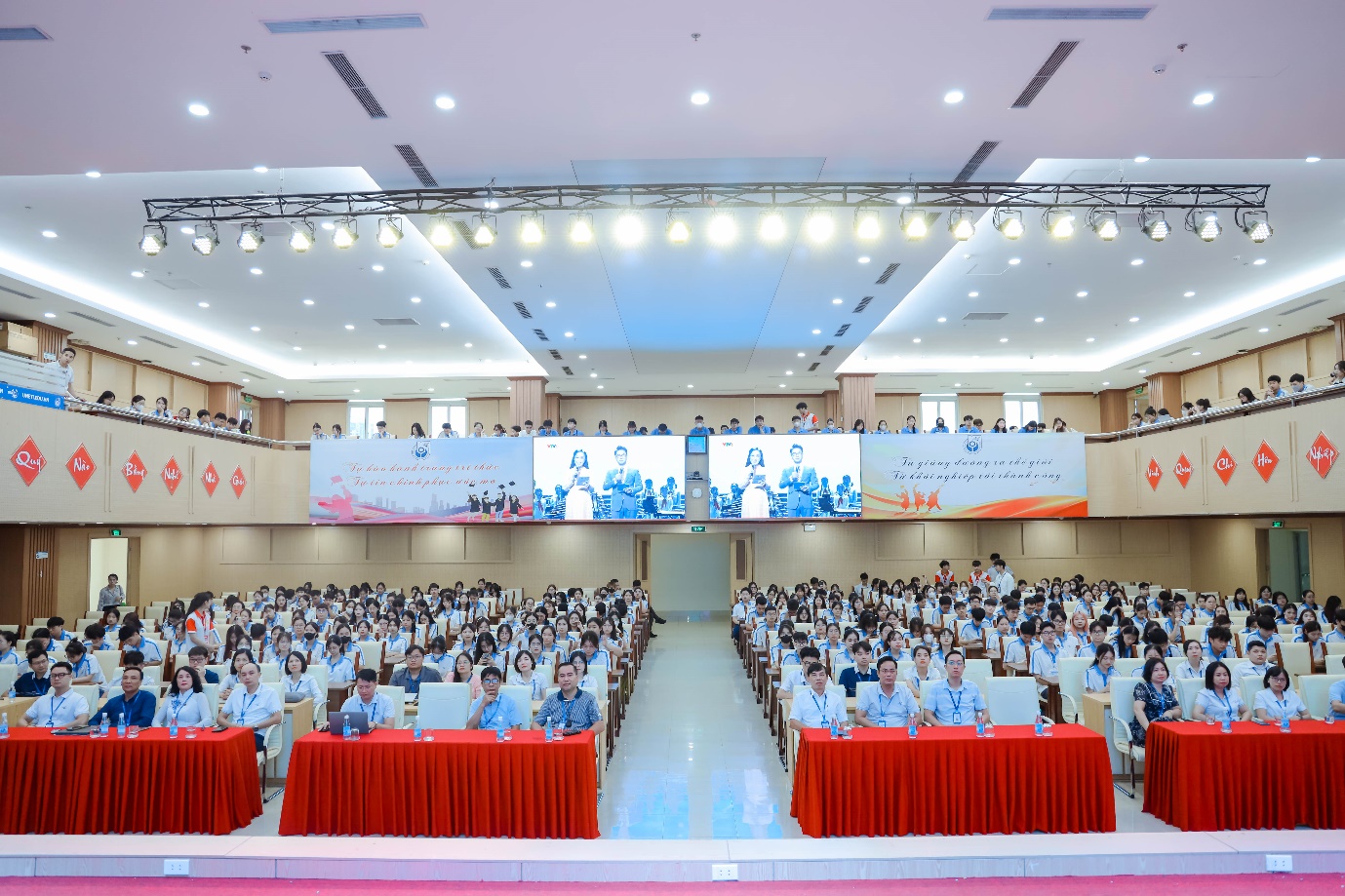 A large group of people sitting in a room Description automatically generated