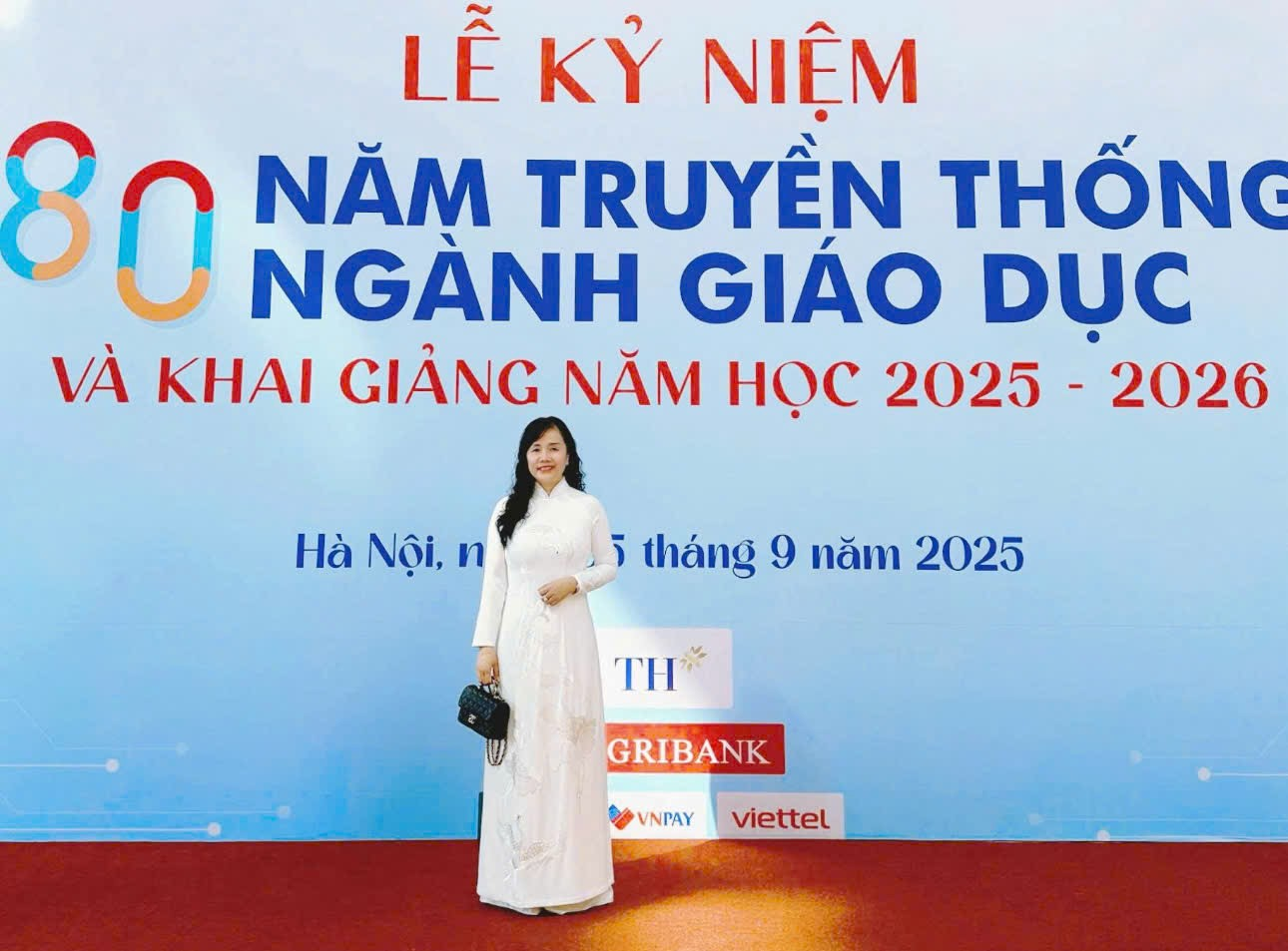 A person standing in front of a sign Description automatically generated