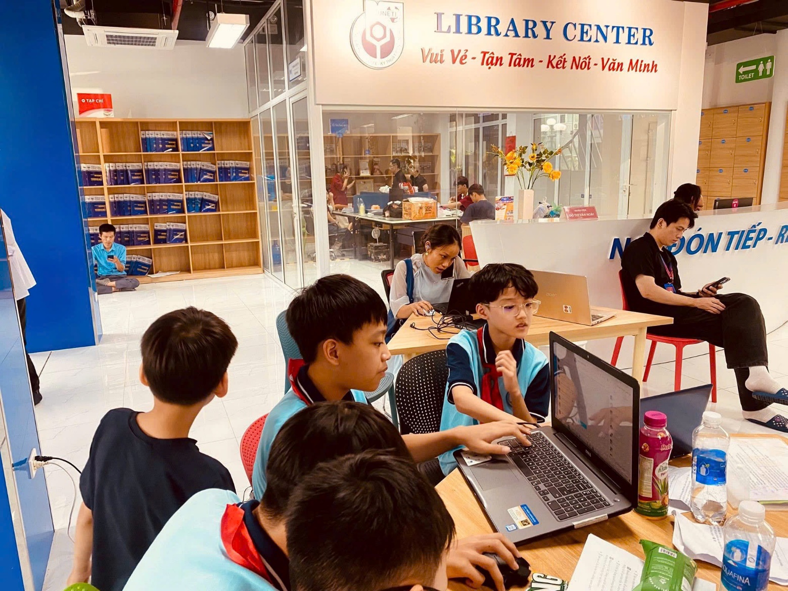 A group of children sitting around a table using a computer AI-generated content may be incorrect.