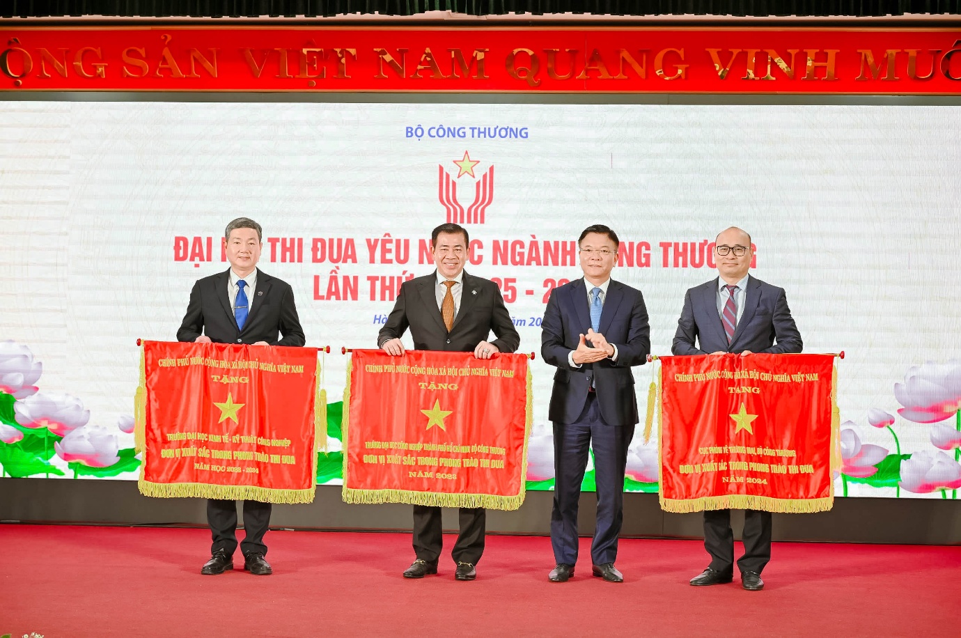 A group of men holding banners Description automatically generated