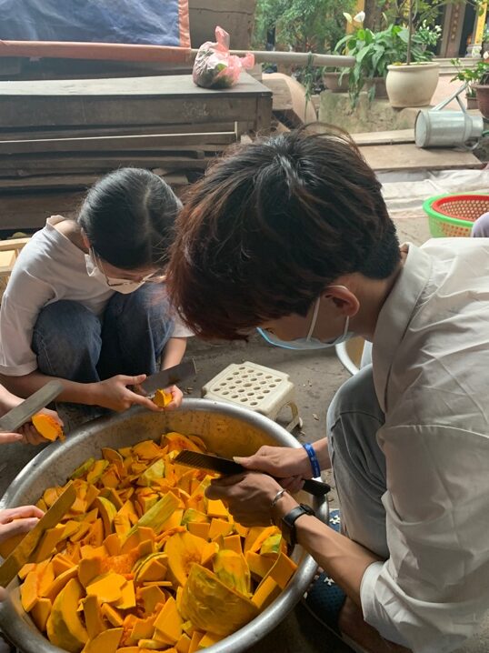 A group of people cutting pumpkin slices AI-generated content may be incorrect.