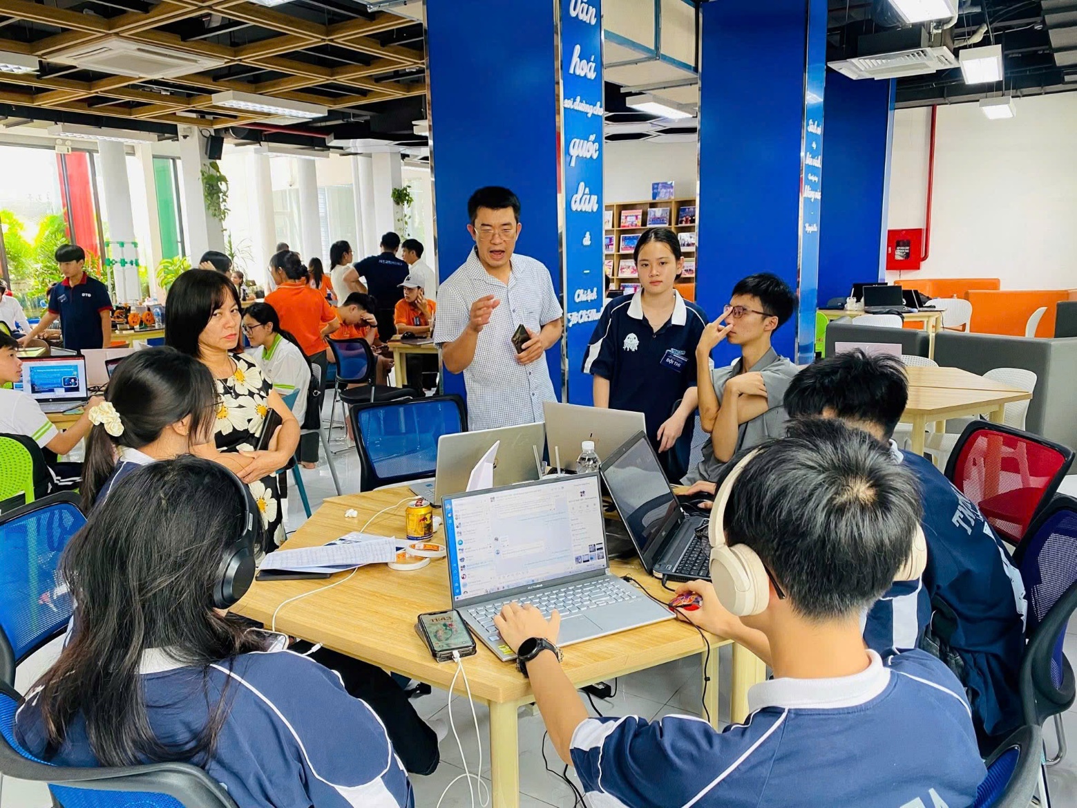 A group of people in a room with computers AI-generated content may be incorrect.