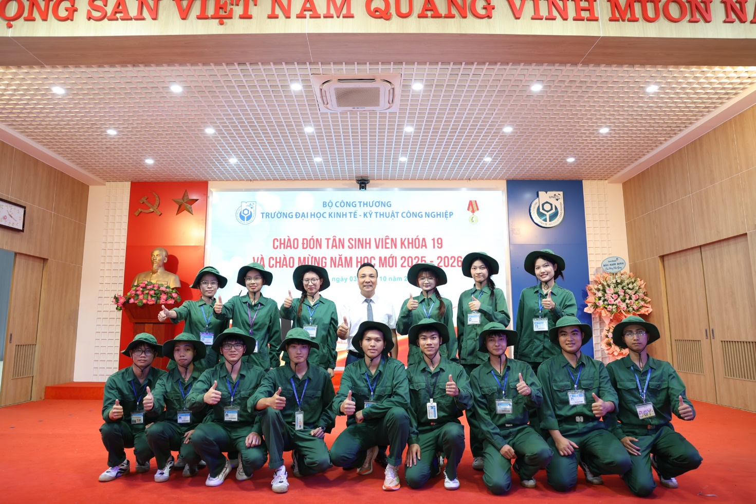 A group of people in green uniforms posing for a photo Description automatically generated