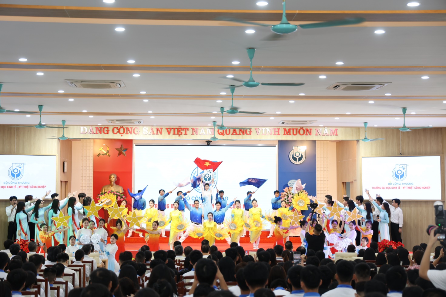 A group of people performing in a room Description automatically generated
