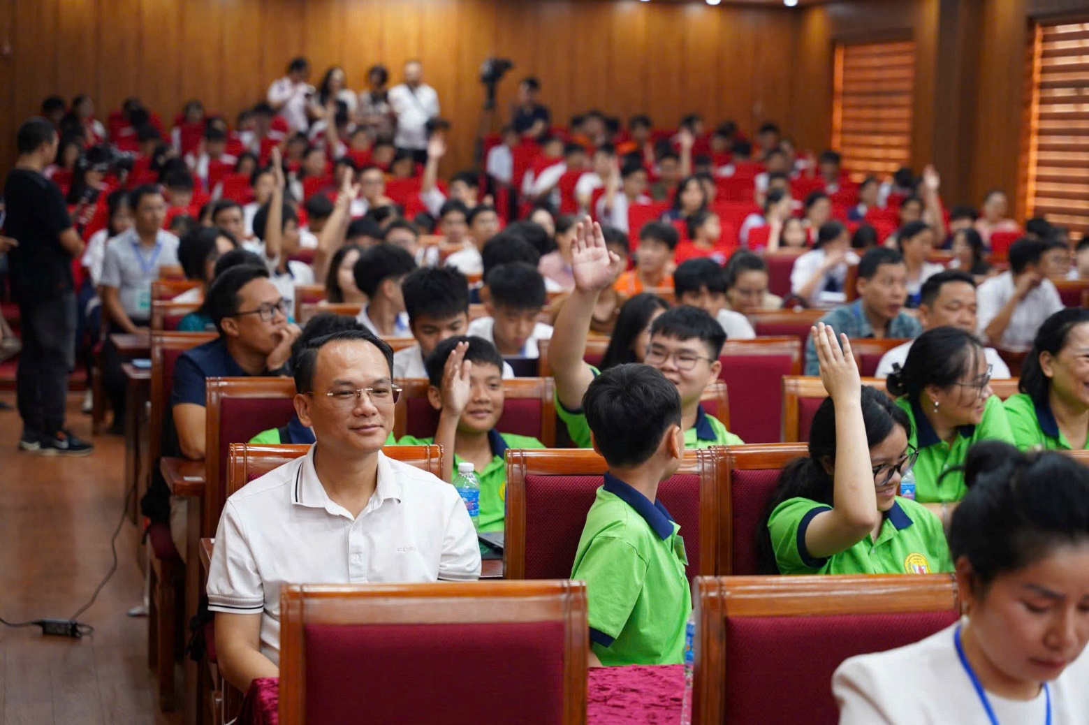 A group of people raising their hands AI-generated content may be incorrect.
