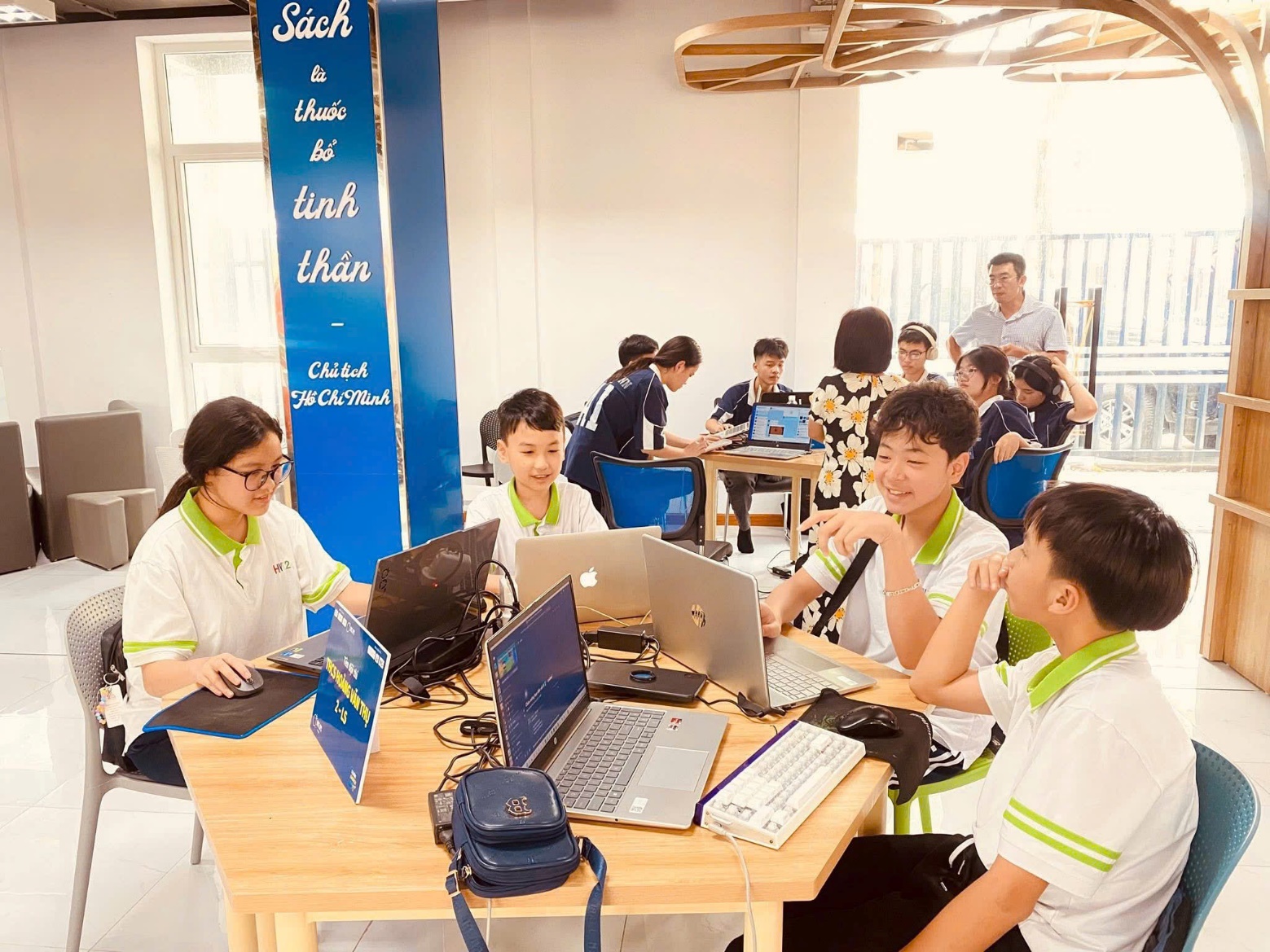 A group of people sitting around a table with laptops AI-generated content may be incorrect.