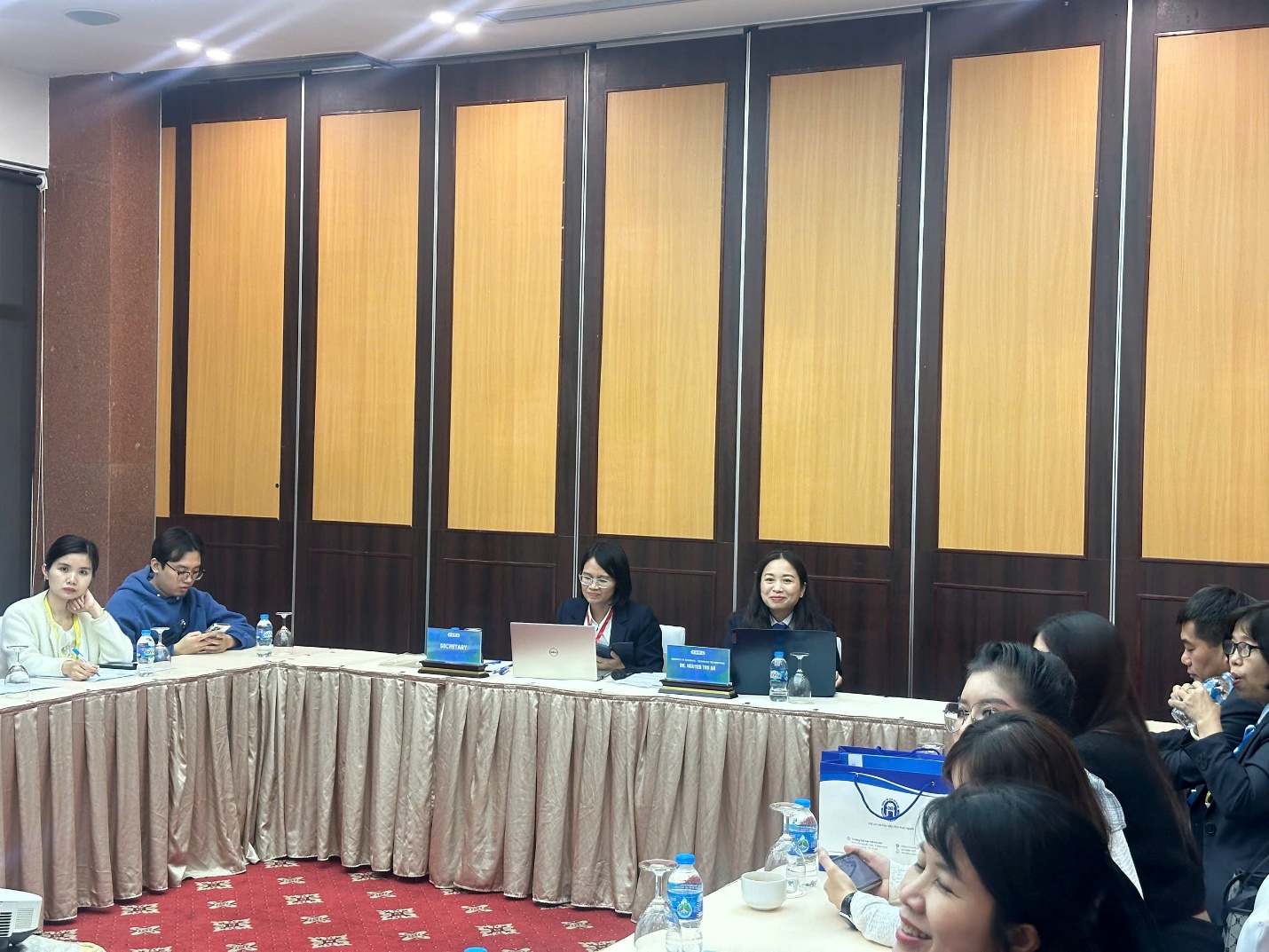 A group of people sitting at a table AI-generated content may be incorrect.