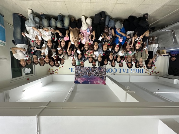 A group of people sitting in a room
AI-generated content may be incorrect.