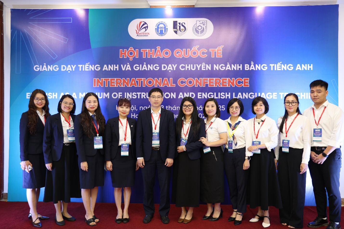 A group of people standing in front of a banner AI-generated content may be incorrect.