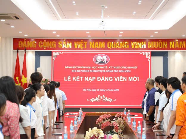 A group of people standing in front of a large sign

Description automatically generated