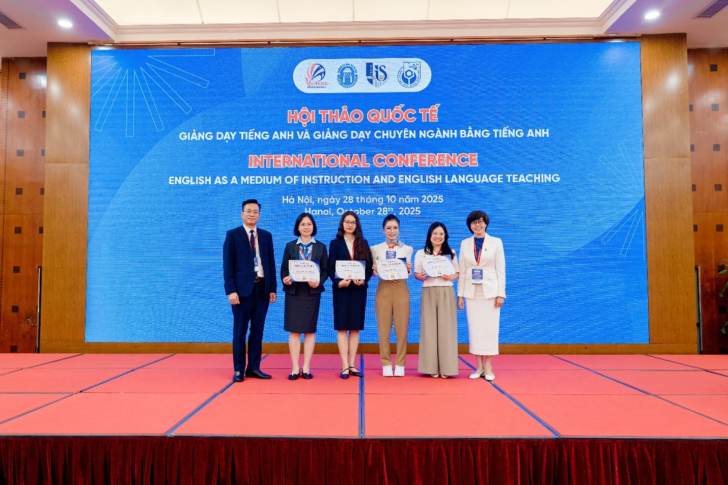 A group of people standing on a stage AI-generated content may be incorrect.