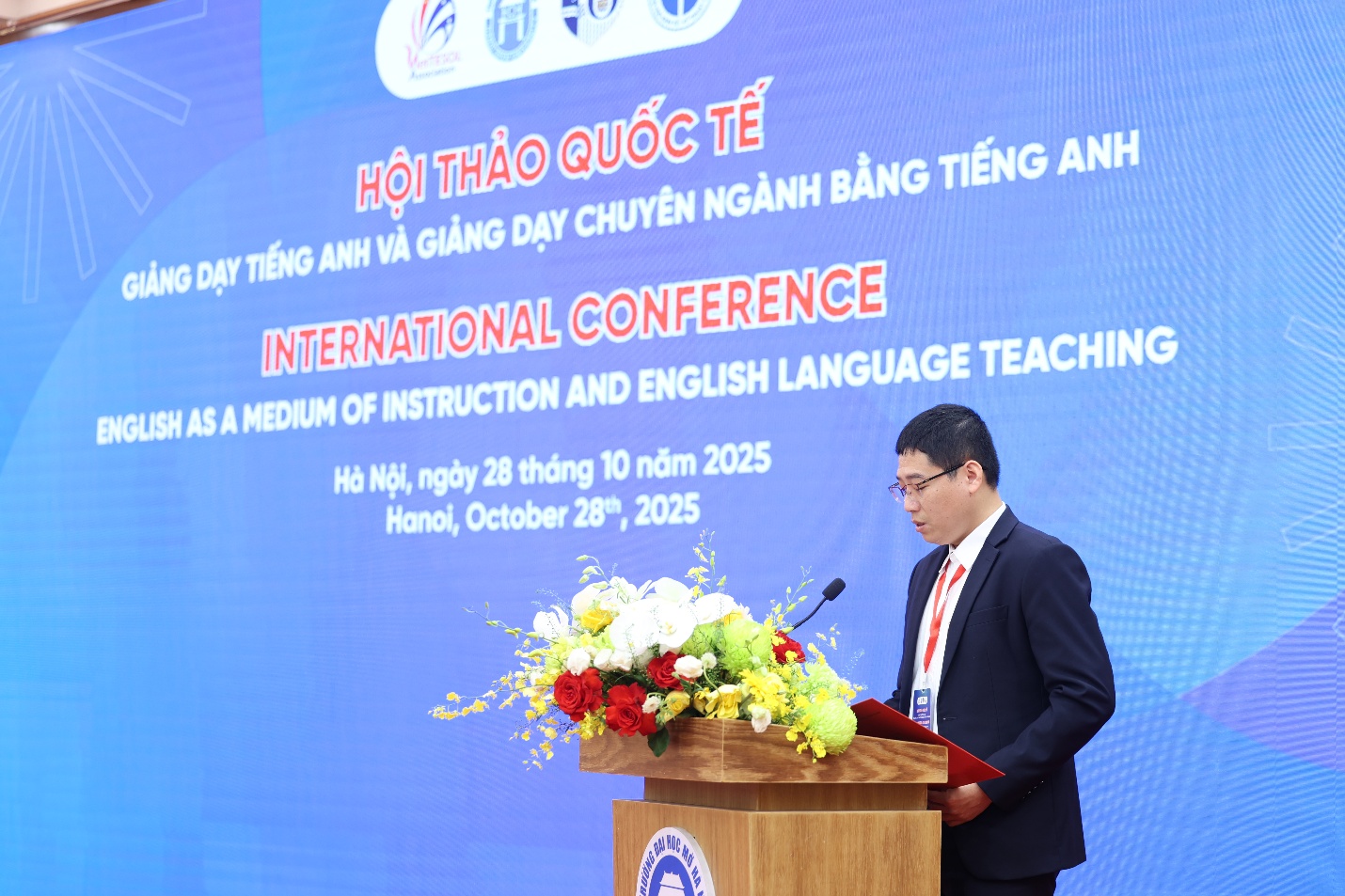 A person standing at a podium with a microphone AI-generated content may be incorrect.