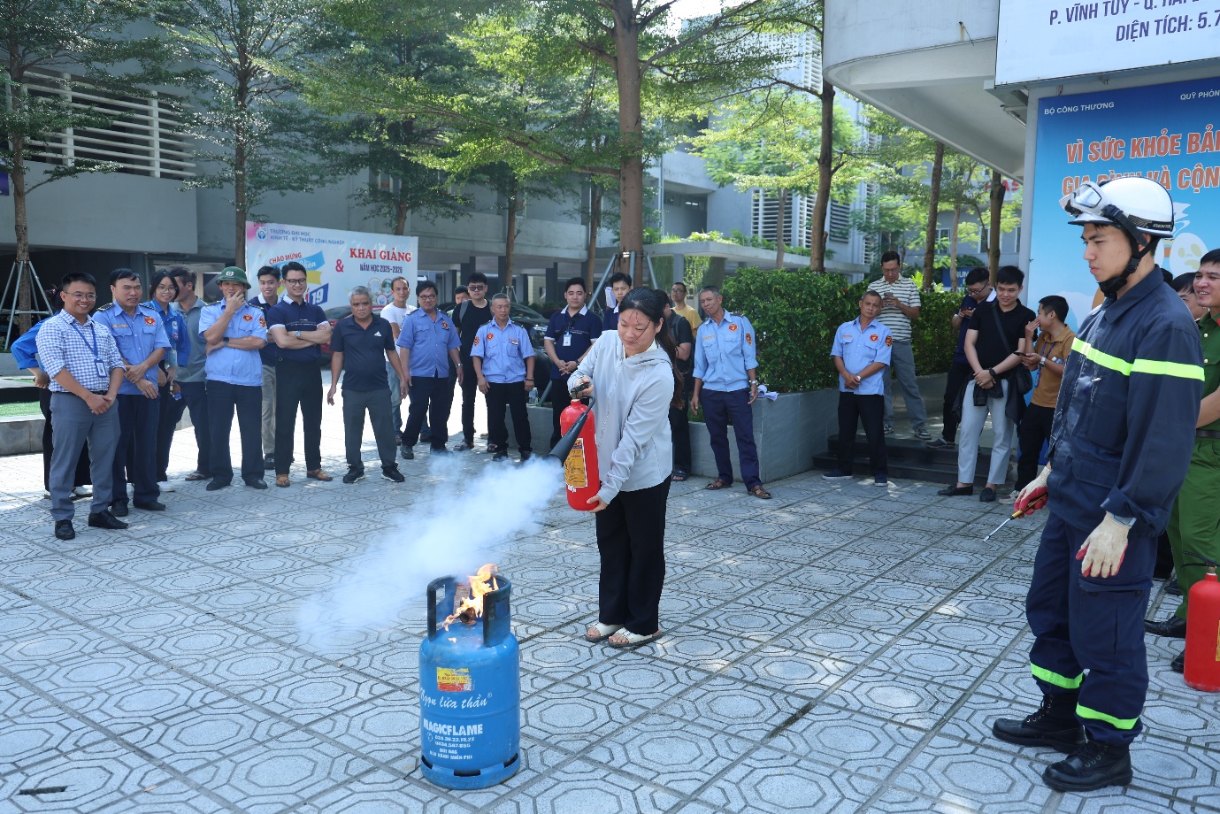 A person standing in front of a fire extinguisher

Description automatically generated
