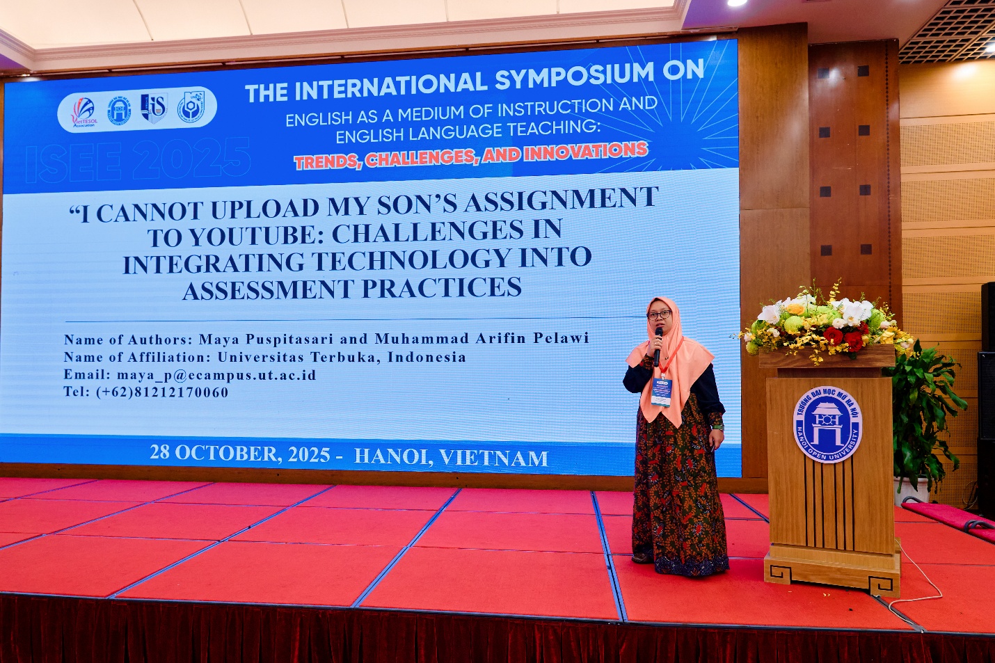 A person standing on a stage AI-generated content may be incorrect.