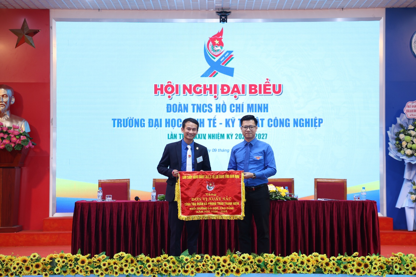 A group of men standing on a stage Description automatically generated