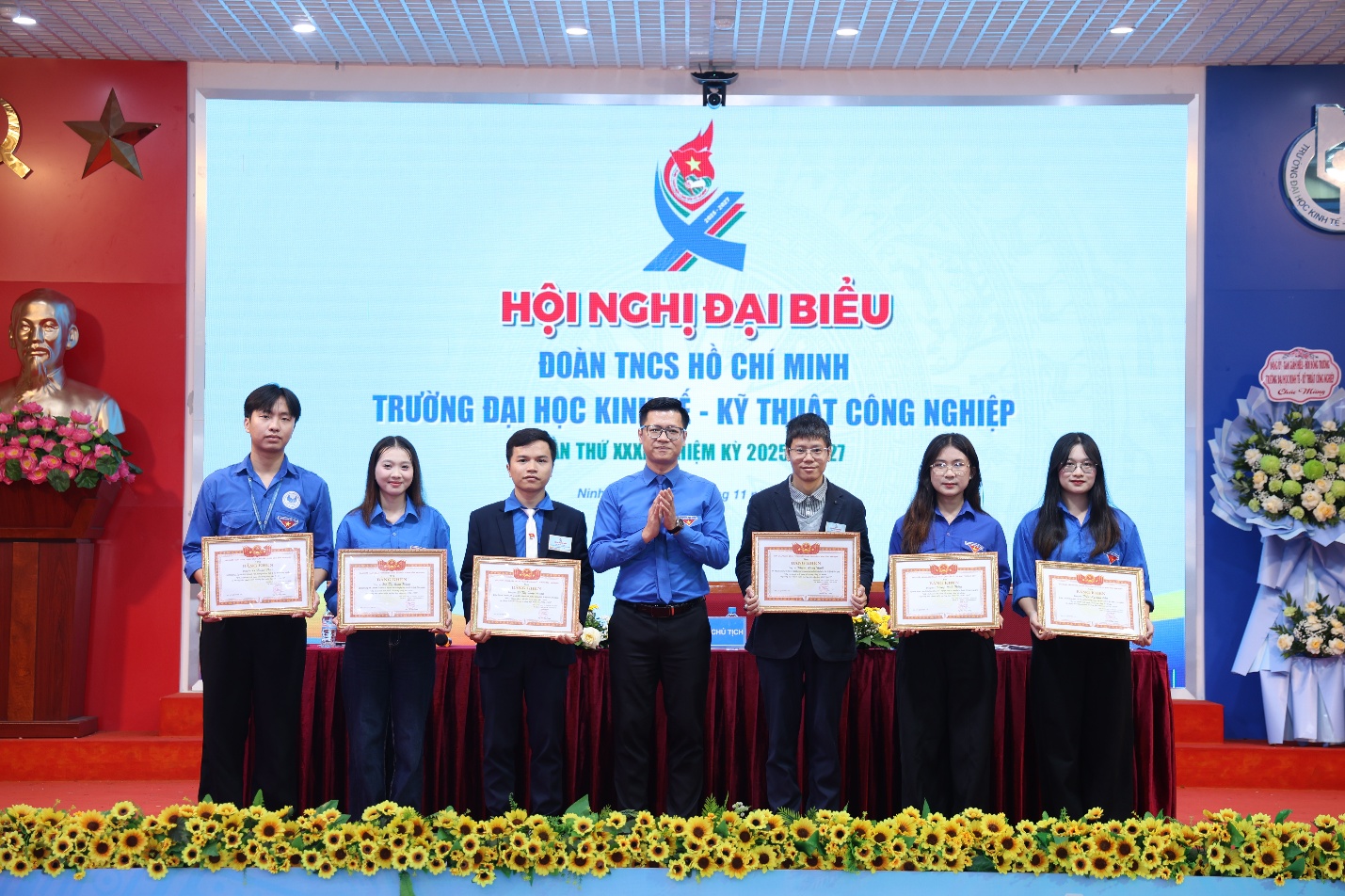 A group of people holding certificates Description automatically generated