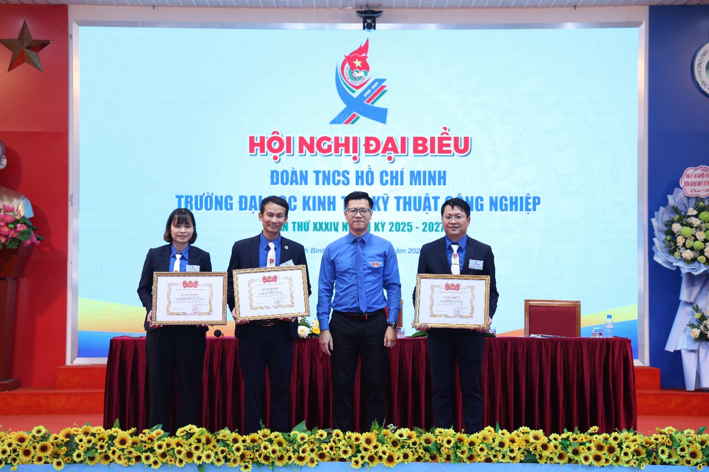 A group of people holding certificates Description automatically generated