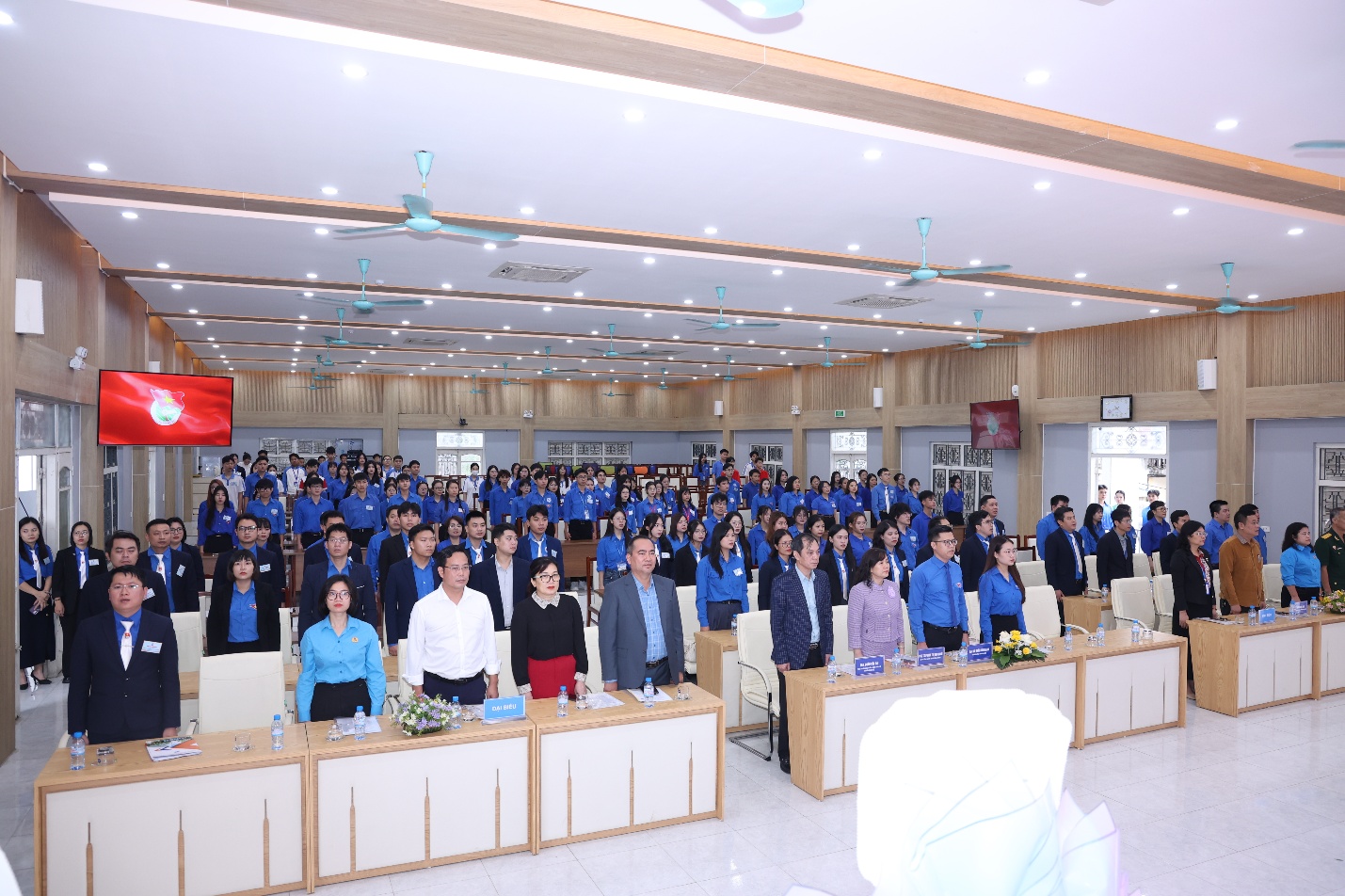 A group of people in a room Description automatically generated