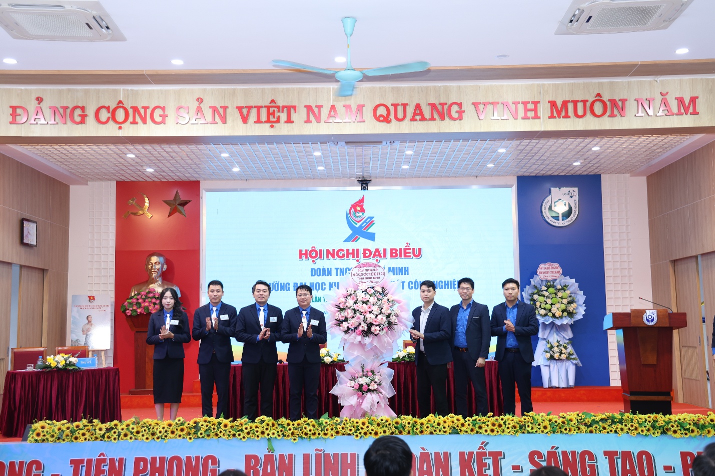 A group of people on a stage Description automatically generated