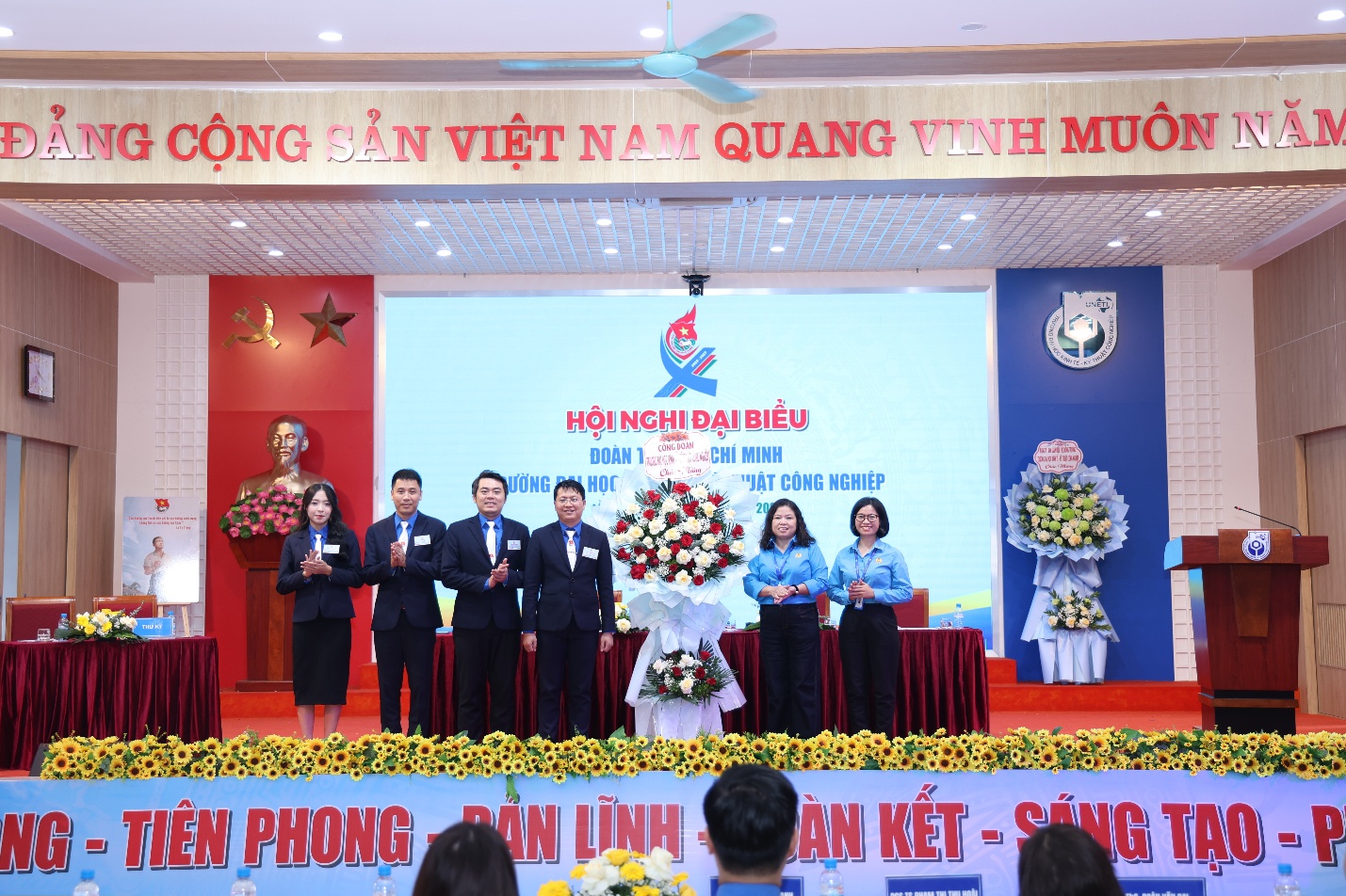 A group of people on a stage Description automatically generated