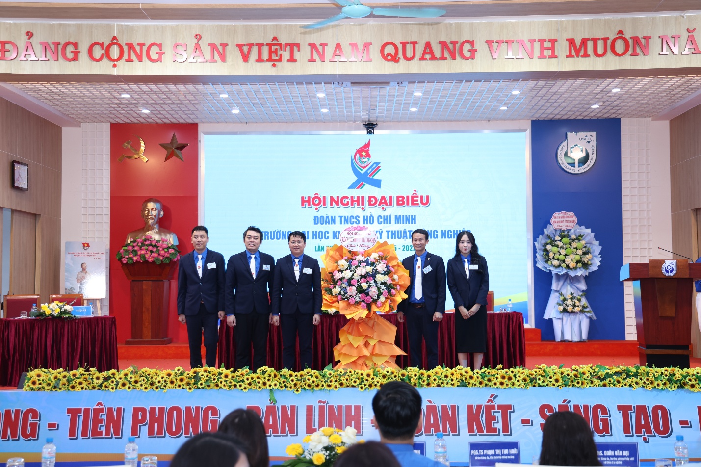 A group of people on a stage Description automatically generated