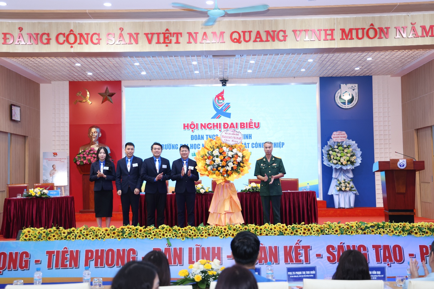 A group of people on a stage Description automatically generated