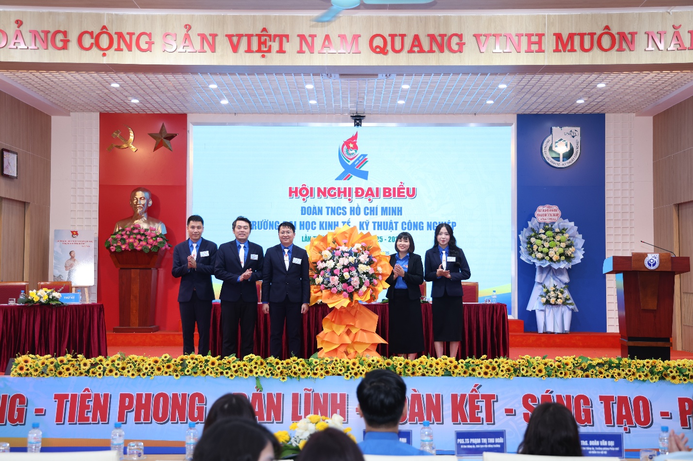 A group of people on a stage Description automatically generated