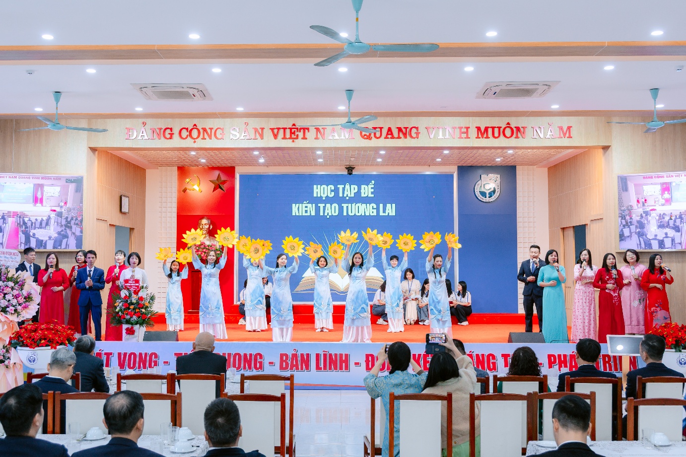 A group of people on a stage Description automatically generated