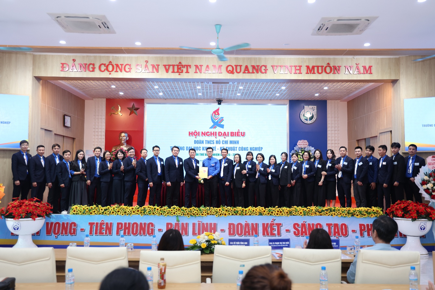 A group of people on a stage Description automatically generated