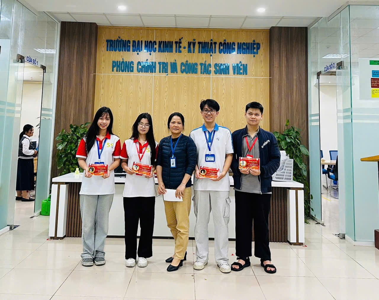 A group of people standing in a room Description automatically generated